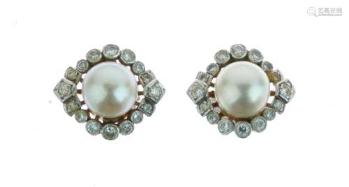 Pair of cultured pearl and diamond earstuds, the 7.8mm diameter pearl enclosed by an eye shaped
