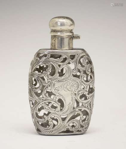 Continental white metal scent bottle, the flask-form body with foliate scroll cage-work overlay,