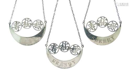 Wang Hing - Three Chinese trade silver spirit labels, each of crescent form with three pierced