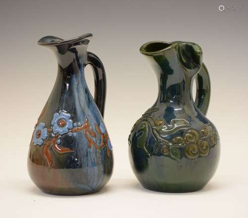 Two small Elton Ware jugs, both with foliate decoration, one being on a blue/brown ground, the other