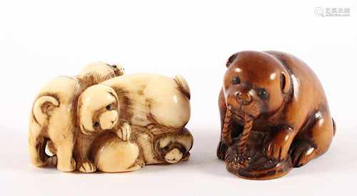 ZWEI NETSUKE HUNDE, a) Elfenbein, Augen schwarzes Horn, während zwei Welpen miteinander balgen steht