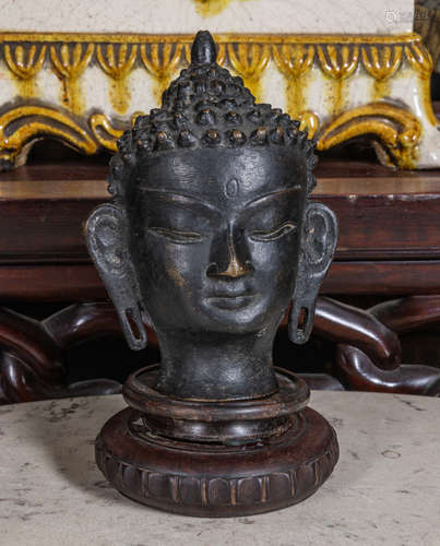 Sino Tibetan bronze buddha head with wood stand