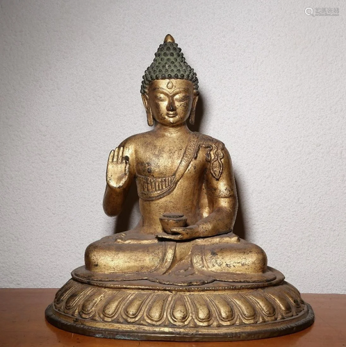 A CHINESE GILT-BRONZE FIGURE OF SAKYAM…