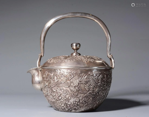 A JAPANESE SILVER TEA POT WITH CARVED PHO…