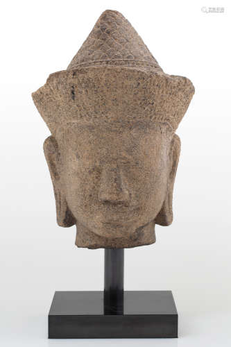 AN ANGKOR WAT STYLE SANDSTONE HEAD OF VISHNU, KHMER, POSSIBLY 12TH CENTURY