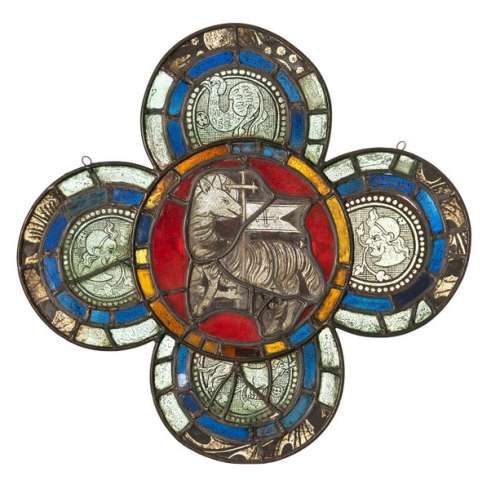 Stained glass window with Lamb of God. Probably France, around 1400. 50 x 50.5 cm. Four-fit. Colourless glass with black enamel painting, blue, red and yellow glass. Central representation of the Lamb of God, in the side fields busts or dog and mythical creature. Additions, partially rest. and best., lead frame renewed. Provenance: For several generations in a German private collection.