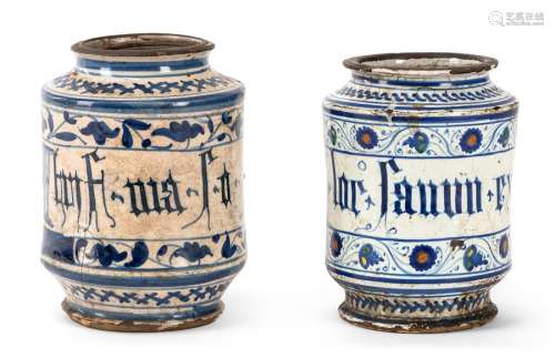 Two Albarelli. Faenza or Venice, 15th or 16th century. H. 19/20 cm. Majolica, white glazed, painted and inscribed in blue or blue and ochre, yellow, green. glaze flakes, cracks, dam. Provenance: From old South German private property.