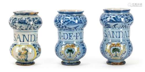 Three Albarelli with Berettino background. Venice, late 16th/early 17th century. H. 20.5/22 cm. Majolica, white glazed, blue floral decoration, indented body with inscriptions, coat of arms painting or John the Baptist. L. best. Provenance: From old South German private property.