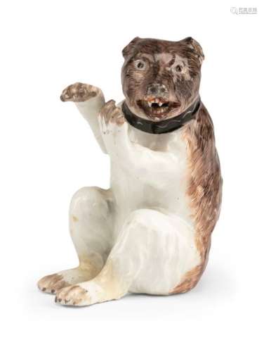Sitting bear. Meissen, circa 1745. H. 9.5 cm. Figure facing left, head and back and paws decorated in brown, a black band with a scraped out white wavy line around the neck, golden chain ring on the back. At the bottom minimal remains of blue sword mark. model by Johann Joachim Kaendler, around 1743/45. paws rest, slightly dam. Provenance: From old South German private property. Shown by Rainer Rückert, Meissener Porzellan 1710-1810, exhibition catalogue BNM, 1966, cat.no. 1171, then owned by Mrs. Carola Roth, Munich.