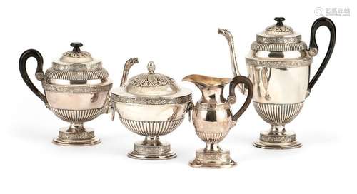 Coffee and tea service. St. Petersburg, circa 1820. H. 20/29 cm. Consisting of coffee pot, teapot, sugar lid tin and milk jug. Silver, partially gold-plated, godron relief and vine borders. Wooden handle. Sugar bowl, coffee pot and teapot with St. Petersburg city mark, master of foaming Alexander Ilitsch Jaschinow, MZ: Gotthard Ferdinand Stang (1780-1821). Addition approx. 2842 gr. Minimally dented. Provenance: German private collection, acquired in the 1990s at a Munich art fair. Cf. Postikova, No. 1143, 1163, 1638.