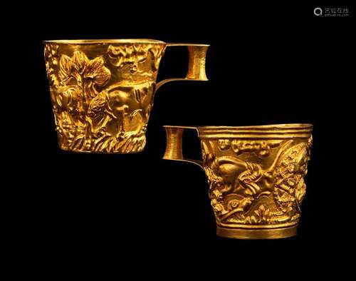 Pair of gold cups modeled after the gold cups from Vaphio. Court jeweller of the Greek Royal House J. Vourakis & Sons, Athens, 1950s/60s. H. Two inches. Replicas of the gold cups of Vaphio in 22kt yellow gold. Cup with double walls and bottom, surrounding motifs of a bull hunt. Applied handling. Stamped 