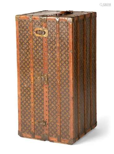 Louis Vuitton Monogram Canvas travel cabinet. about the 1920s/30s. 113x56x55 cm. Printed canvas, wood, leather edges, brass fittings. Inside drawers, removable case, ironing rail and hanger. Brass buckle with firmament, on the central buckle model no. 060481, in red colour owner monogram 