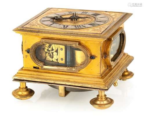 Single-handed horizontal table clock. MZ (Martinus Zoller 1590-1633), Augsburg, around 1630. 7x10x10 cm. Fire gilded bronze case with glazed sides. Horizontal, silver-plated dial ring with Roman hours and beautifully worked iron hand and corner decorations. Hour strike on bell. Fire-gilded, magnificently worked movement: finely engraved, applied floral ornaments, dolphin hammers and flower-shaped spindle bridge. Verge gear with chain and worm. Monogrammed MZ. Rest. Erg. provenance: important southern German watch collection in longstanding private ownership. Acquired by Ineichen/Zurich in October 1973. See G. H. Baillie, Watchmakers & Clockmakers of the World, Volume 1, p. 353.