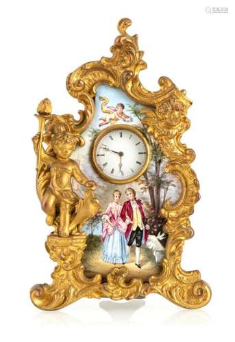 Enamel pocket watch stand. Vienna, late 19th century. H. 12.5 cm. Gilded bronze stand in rococo style. Plaque with fine enamel painting on the front side. Inset pocket guide in 585 yellow gold. White enamel dial best. Cylinder movement.