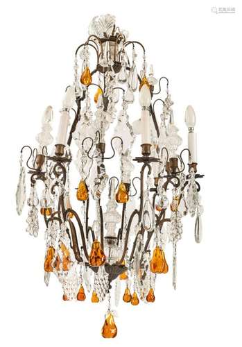 Chandelier. Rococo style, circa 1900. H. 96 cm. Burnished metal frame. Nine flames. Rich, partly coloured glass hanging. senile Electrif. Provenance: Private collection Baden-Württemberg.