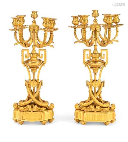 Pair of classicistic gorgeous girandoles. France/Paris, circa 1850. H. 64 cm. Seven-flame. Chased and gilded bronze. senile Traces of subsequent electrif.