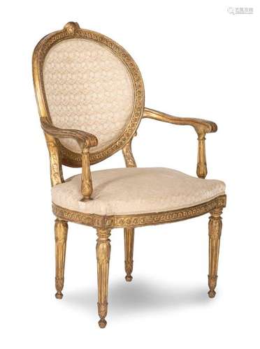 Louis XVI armchair. Probably Italy, 18th century. H. 106 cm. Richly carved and gilded. Rest. Elegant chair with filigree carving and attractive patina. The backrest is crowned by a Hermes head.