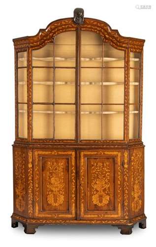 Rococo style display case. Netherlands, 19th century. 222x140x31 cm. Two-door lower part. Three-sided glazed top with two doors. Rich floral decorations. Carving trimming. Rest. Age-sp. mahogany and others, partly coloured and engraved. Provenance: South German private property.