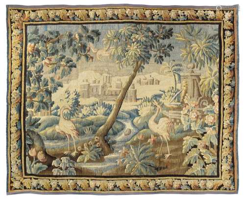 Verdure. Flanders, 1st half 18th century 258 x 351 cm. A very decorative pictorial work in wool and silk, depicting an idealized landscape with a forked river course, herons, trees and plants. In the background a castle or monastery architecture watches over the idyllic scenery. The paradisiacal character is also underlined by a fountain on the right-hand side. Such works of art played a decisive role in the decoration requirements of large halls, especially since cyclical depictions with mythological or religious themes were particularly popular. In the baroque age, paintings, engravings or drawings often served as models for wool knitting. The painter and etcher Roeland Savery (1576-1639) is best known for his Flemish art, especially for his landscapes with rich animal scenes. In his compositions, herons are repeatedly found along the course of rivers. Provenance: acquired in 1955 in Paris in the art trade, since then in private ownership in southern Germany. - Min. age ch. and min. rep. Very well preserved overall.