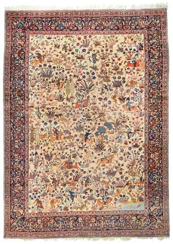 Kirman. Southern Persia, mid-20th century. 460 x 330 cm. An attractive white-ground carpet decorated with a continuous pattern repeat of graceful floral ornaments, stylised tree motifs and hunting scenes. A magnificent dark blue-ground main border. Provenance: South German private property. - Min. usessp.