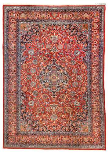 Keshan Dabir. Central Persia, second third of the 20th century. 427 x 303 cm. Classically designed, splendid manufactory carpet in the captivating quality of the Dabir workshop. The delicate floral vines and palmette motifs stand out in pastel colouring against the red-ground ground and the border, which also has a red ground. Min. agessp. Overall very well preserved.