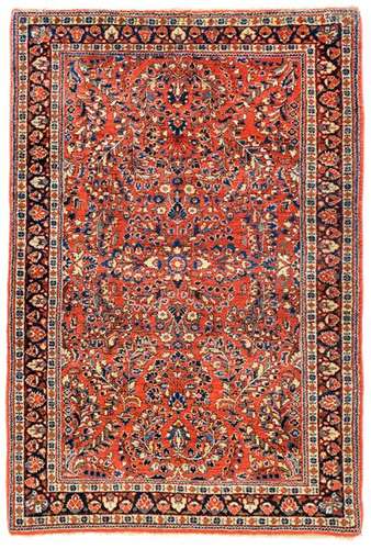 Reimport Sarouk. Western Persia, circa 1930. 153 x 103 cm. A classic red ground with a field design of curved flowering shrubs and palmettes. Dense and high wool pile of good quality. Decorative knotting work in an attractive format. Min. rep. Insg. well preserved.