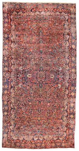 Reimport Sarouk. Western Persia, circa 1940. 540 x 275 cm. A red-ground pile-work typical of the provenance with a special size and extravagant border ornamentation. Provenance: Private collection, Hamburg. - Min. age and usage esp. in good condition.