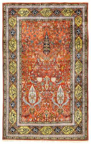 Agra silk. India, second third of the 20th century. 219 by 139 cm. A fine and dense silk pile distinguishes this knotting work. The shimmering red field is covered with a pattern repeat of paradisiacal plants and animals. Three larger cypress-like tree motifs stand out in a pyramidal arrangement. Iconographically, this garden pattern refers to ancient models from the Safavid period. A striking border of large cartouches filled with calligraphy. Bright colouring and shiny pile. Min. age-sp. insg. well preserved.