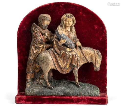 Holy family on the run. Flemish, circa 1500. 26.5x24x5.5 cm. Oak, worked in relief. On a patch of grass, the group of four figures rises up from Bethlehem to Egypt on their flight from King Herod. Mary is sitting on a donkey with little Jesus wrapped in a baby's paw wrapped in a blanket. Josef, holding a stick with luggage in his hand, stands to the left behind it. Remains of the original version, several times overlooked. In the base area larger addition, legs of the donkey partly completed, 1 leg missing. senile Provenance: Formerly the Carl von Weinberg Collection (1861-1943). In 1949, he returned to his next of kin in the succession of Richard von Szilvinyi and has been in direct family ownership ever since. Formerly Weinberg'sche Villa Waldfried, Frankfurt a.M. Cf. a small half-length figure of Joseph of Arimathea in the Suermond-Ludwig-Museum, Aachen, probably from Antwerp. Lit. catalogue Dutch Sculptures from 1130 to 1600, no. 60, foreword by Carl von Weinberg (PDF)