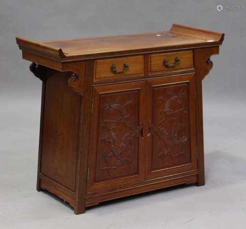 A late 20th century Chinese hardwood side cabinet with carved decoration, fitted with two drawers