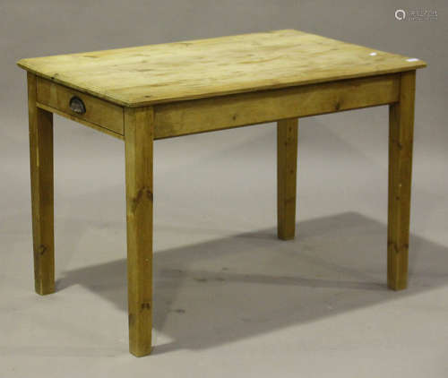 An early 20th century pine side table, the rectangular top above an end drawer, raised on block