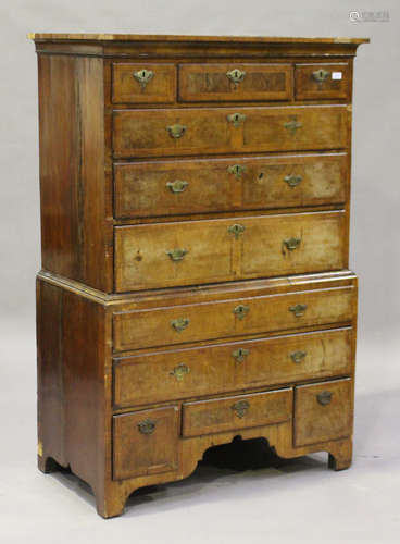 A George I walnut chest-on-chest with feather and crossbanded borders, the cavetto moulded