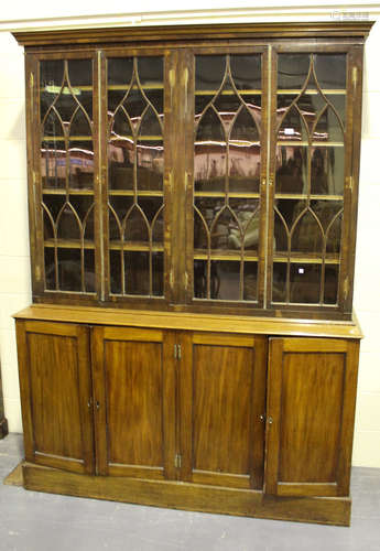 A 19th century and later mahogany bookcase cabinet, the moulded pediment above four astragal