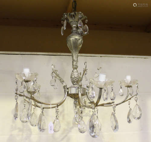 A mid-20th century silvered cast metal five-branch chandelier, hung with large clear glass drops,