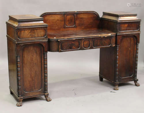 An early Victorian mahogany twin pedestal sideboard, fitted with four frieze drawers and panelled