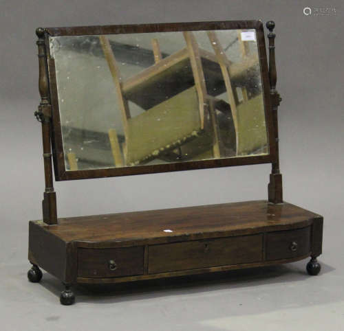 A late George III mahogany swing frame toilet mirror, the base fitted with three drawers, on