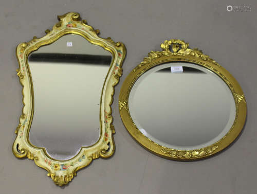 An early 20th century gilt composition circular wall mirror, the reeded frame with laurel wreath