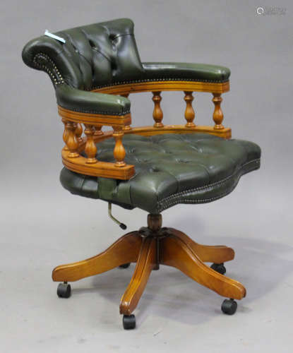 A 20th century reproduction mahogany and green leather tub back office chair with studwork