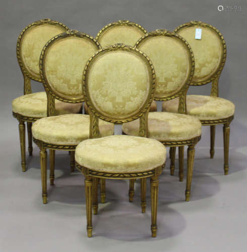 A set of six early 20th century Louis XVI style gilt painted chairs, the overstuffed seats and backs