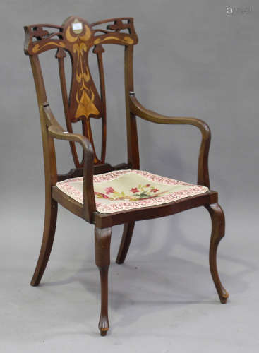 An Edwardian Art Nouveau mahogany elbow chair with pierced and inlaid decoration, on cabriole