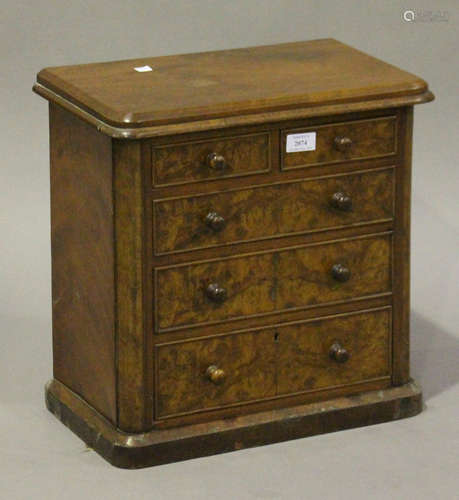 A Victorian burr walnut diminutive table-top chest of two short and three long drawers, on a