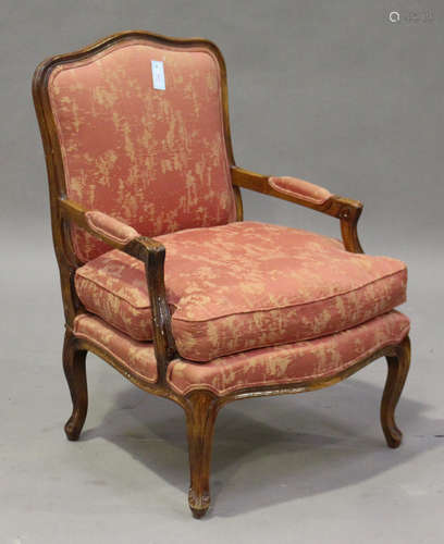 A late 20th century Louis XV style stained beech fauteuil armchair, the upholstered seat and back