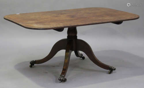 A Regency mahogany tip-top breakfast table with ebony stringing, raised on a turned column and sabre