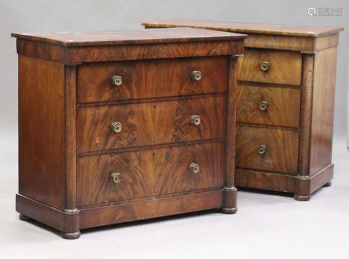A pair of early 19th century figured mahogany chests, each fitted with four drawers flanked by