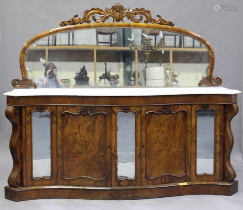 A Victorian walnut mirror back side cabinet with white marble top, the serpentine front fitted