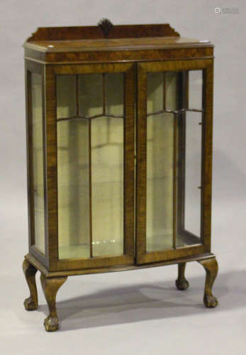 A 20th century Queen Anne style walnut display cabinet, fitted with a pair of astragal glazed doors,