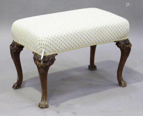 An early 20th century George I style walnut stool, the overstuffed seat upholstered in cream