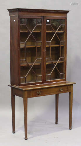 A 19th century mahogany bookcase, fitted with a pair of astragal glazed doors, the base fitted