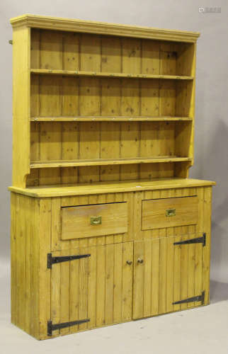 A 20th century pine dresser, the shelf back above two drawers and cupboards, height 217cm, width