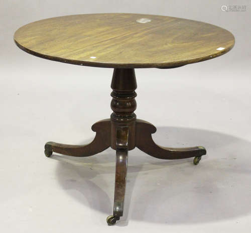 A late George III mahogany circular tip-top supper table, on a turned column and tripod sabre